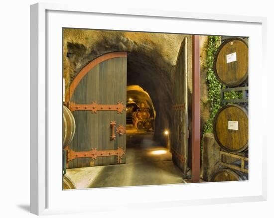 Oak Barrels Stacked Outside of Open Door To Aging Caves at Ironstone Winery, California, USA-Janis Miglavs-Framed Photographic Print