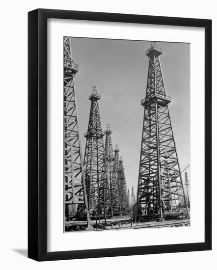 Oil Well Rigs in a Texaco Oil Field-Margaret Bourke-White-Framed Photographic Print