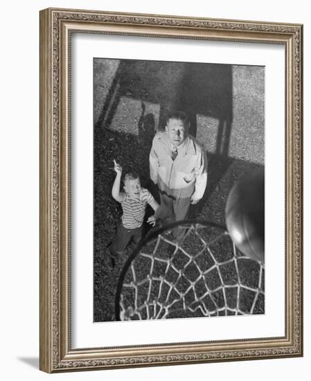 Oklahoma A&M Basketball Coach Hank Iba Watching a Young Boy Shooting a Basket-Myron Davis-Framed Photographic Print