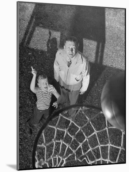 Oklahoma A&M Basketball Coach Hank Iba Watching a Young Boy Shooting a Basket-Myron Davis-Mounted Photographic Print