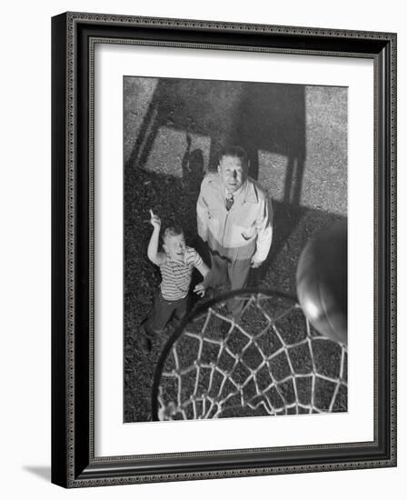 Oklahoma A&M Basketball Coach Hank Iba Watching a Young Boy Shooting a Basket-Myron Davis-Framed Photographic Print