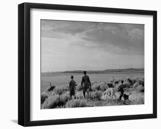 Oklahoma Farmer with His Two Sons and Their Dogs Walking Toward a Fenced in Field-Alfred Eisenstaedt-Framed Photographic Print