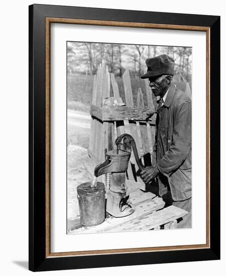 Old African American Sharecropper Dave Alexander Using Water Pump to Draw Water-Alfred Eisenstaedt-Framed Photographic Print