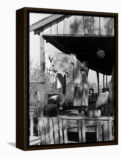 Old African American, Wife of Sharecropper, Lizzie Alexander Hanging Laundry to Dry on Her Porch-Alfred Eisenstaedt-Framed Premier Image Canvas