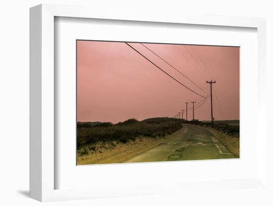 Old Curved Road through Deserted Coastline at Sunset under a Soft Pink Sky-Sanghwan Kim-Framed Photographic Print