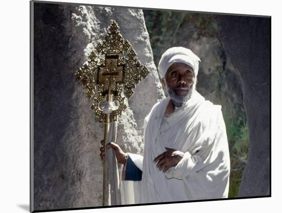 Old Ethiopian Orthodox Priest Holds a Large Brass Coptic Cross at Rock-Hewn Church of Adadi Maryam-Nigel Pavitt-Mounted Photographic Print