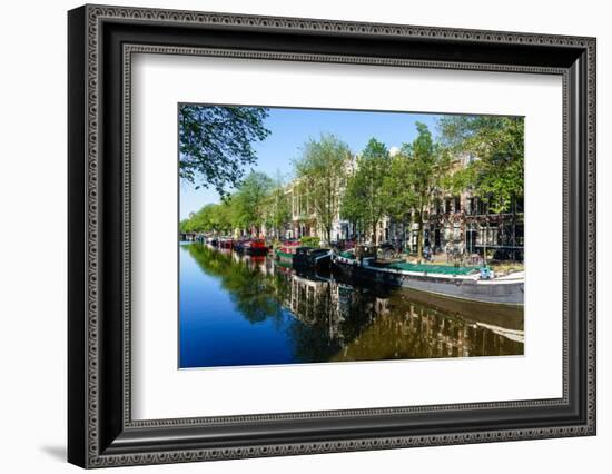 Old gabled buildings reflecting in a canal, Amsterdam, North Holland, The Netherlands-Fraser Hall-Framed Photographic Print