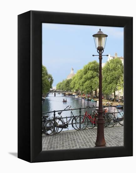 Old Gas Lamp Post and Bicycles on a Bridge over a Canal in Amsterdam, the Netherlands-Miva Stock-Framed Premier Image Canvas