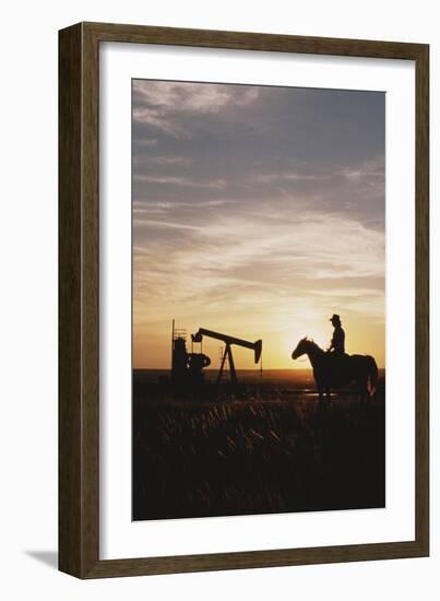 Old West, New West, Man Sitting on Horse with Oil Refinery at Sunset-David R^ Frazier-Framed Photographic Print