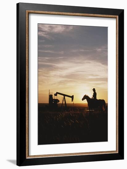 Old West, New West, Man Sitting on Horse with Oil Refinery at Sunset-David R^ Frazier-Framed Photographic Print