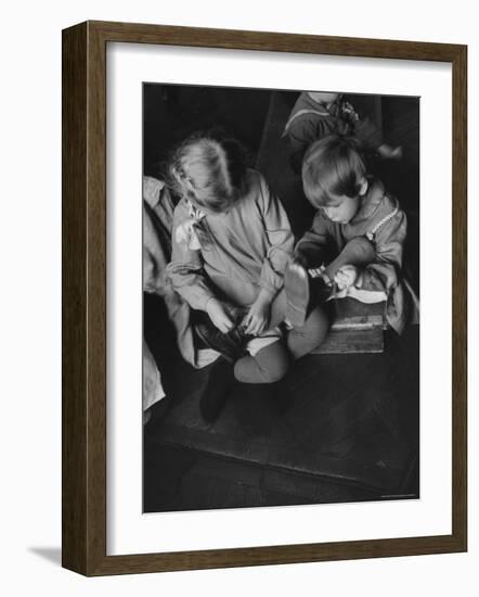 Older Girl Helping Younger Tie Shoe in Russian Kindergarten-Carl Mydans-Framed Photographic Print