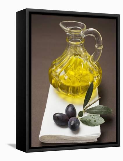 Olive Sprig with Black Olives, Carafe of Olive Oil Behind-null-Framed Premier Image Canvas
