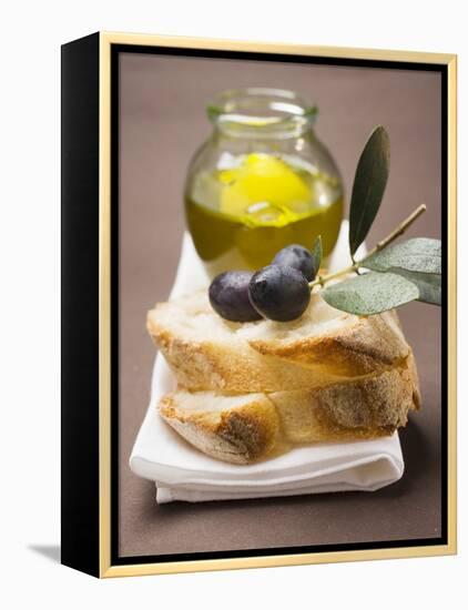Olive Sprig with Black Olives on White Bread, Olive Oil Behind-null-Framed Premier Image Canvas