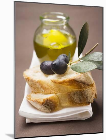 Olive Sprig with Black Olives on White Bread, Olive Oil Behind-null-Mounted Photographic Print