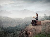 Woman Sitting On A Suitcase And Reading A Book With Landscape On The Background-olly2-Art Print
