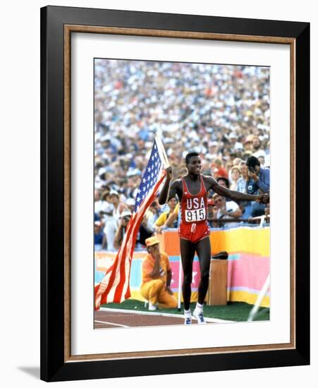 Olympic Games in Los Angeles, 1984 : 100M : Carl Lewis Winner-null-Framed Photo