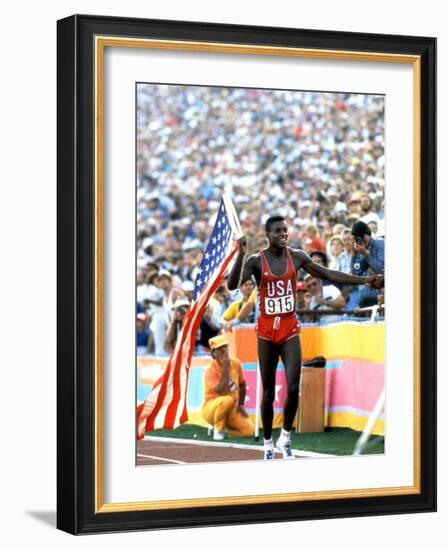 Olympic Games in Los Angeles, 1984 : 100M : Carl Lewis Winner-null-Framed Photo