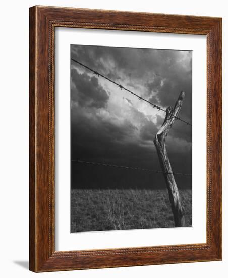 On a Small Farm, Ominous Clouds Overhead, Outlined by Barbed Wire Fencing-Nat Farbman-Framed Photographic Print