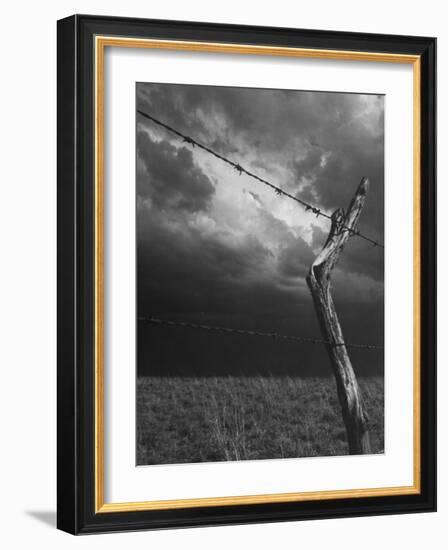 On a Small Farm, Ominous Clouds Overhead, Outlined by Barbed Wire Fencing-Nat Farbman-Framed Photographic Print