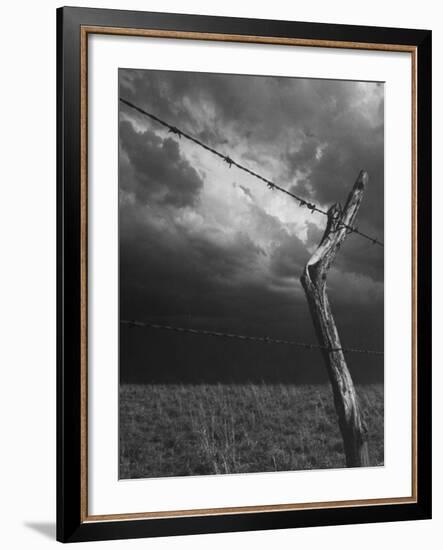 On a Small Farm, Ominous Clouds Overhead, Outlined by Barbed Wire Fencing-Nat Farbman-Framed Photographic Print