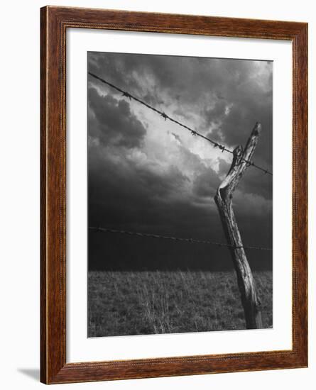 On a Small Farm, Ominous Clouds Overhead, Outlined by Barbed Wire Fencing-Nat Farbman-Framed Photographic Print