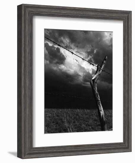 On a Small Farm, Ominous Clouds Overhead, Outlined by Barbed Wire Fencing-Nat Farbman-Framed Photographic Print