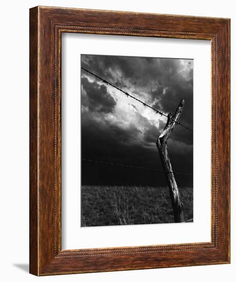 On a Small Farm, Ominous Clouds Overhead, Outlined by Barbed Wire Fencing-Nat Farbman-Framed Photographic Print