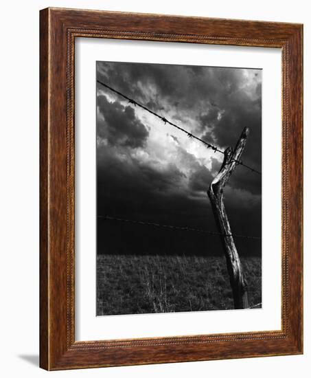 On a Small Farm, Ominous Clouds Overhead, Outlined by Barbed Wire Fencing-Nat Farbman-Framed Photographic Print