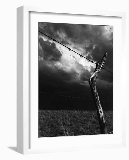 On a Small Farm, Ominous Clouds Overhead, Outlined by Barbed Wire Fencing-Nat Farbman-Framed Photographic Print