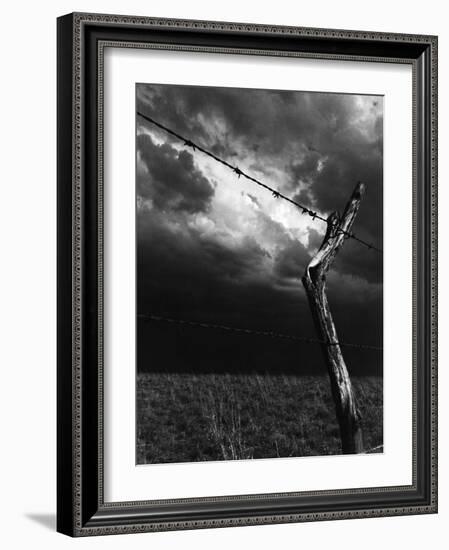 On a Small Farm, Ominous Clouds Overhead, Outlined by Barbed Wire Fencing-Nat Farbman-Framed Photographic Print