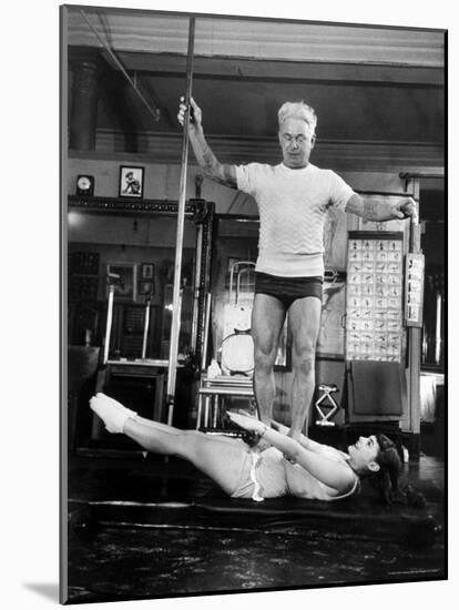 Opera Singer Roberta Peters Balancing Her Trainer, Joseph Pilates, on Her Operatic Breadbasket-Michael Rougier-Mounted Premium Photographic Print