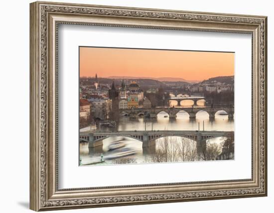 Orange sky at sunset on the historical bridges and buildings reflected on Vltava River, Prague, Cze-Roberto Moiola-Framed Photographic Print