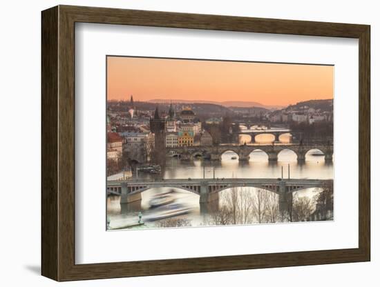 Orange sky at sunset on the historical bridges and buildings reflected on Vltava River, Prague, Cze-Roberto Moiola-Framed Photographic Print