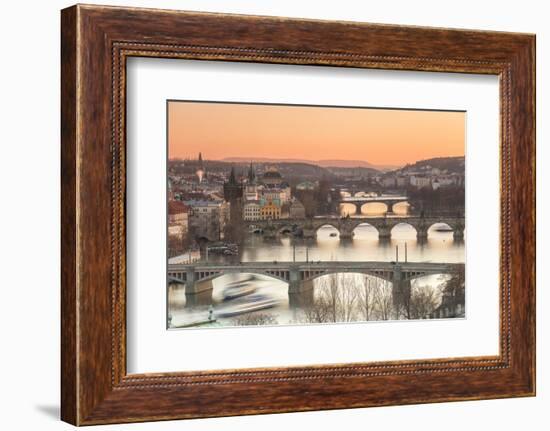 Orange sky at sunset on the historical bridges and buildings reflected on Vltava River, Prague, Cze-Roberto Moiola-Framed Photographic Print