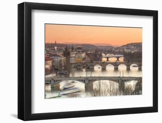 Orange sky at sunset on the historical bridges and buildings reflected on Vltava River, Prague, Cze-Roberto Moiola-Framed Photographic Print