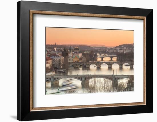 Orange sky at sunset on the historical bridges and buildings reflected on Vltava River, Prague, Cze-Roberto Moiola-Framed Photographic Print