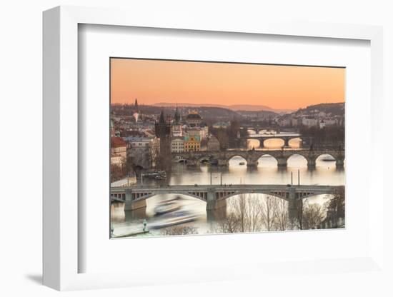 Orange sky at sunset on the historical bridges and buildings reflected on Vltava River, Prague, Cze-Roberto Moiola-Framed Photographic Print