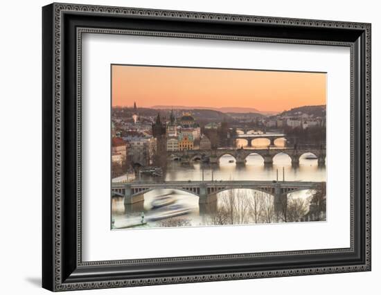 Orange sky at sunset on the historical bridges and buildings reflected on Vltava River, Prague, Cze-Roberto Moiola-Framed Photographic Print