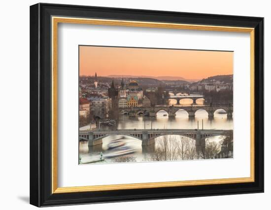 Orange sky at sunset on the historical bridges and buildings reflected on Vltava River, Prague, Cze-Roberto Moiola-Framed Photographic Print
