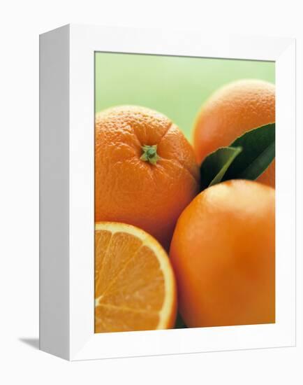 Oranges with Leaves Close Up-Leigh Beisch-Framed Premier Image Canvas