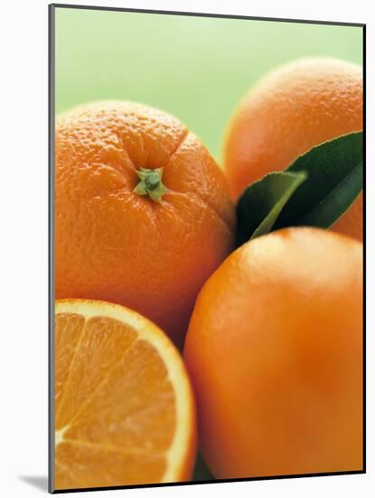 Oranges with Leaves Close Up-Leigh Beisch-Mounted Photographic Print