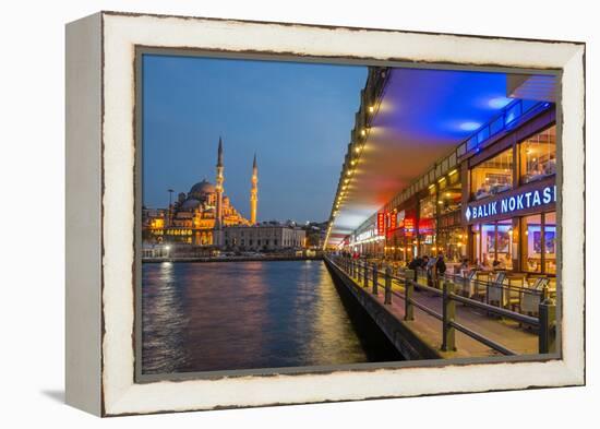 Outdoor Restaurants under Galata Bridge with Yeni Cami or New Mosque at Dusk, Istanbul-Stefano Politi Markovina-Framed Premier Image Canvas