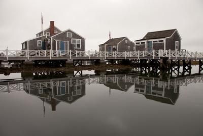 Over The Water Cottages Reflect Off The Calm Waters In The