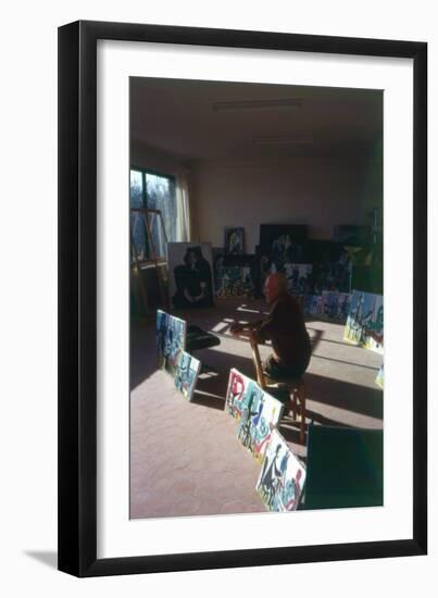 Pablo Picasso (1881-1973) in His Studio Surrounded by His Series 'Le Peintre et Son Modele'-French Photographer-Framed Photographic Print