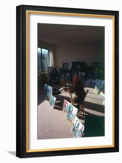 Pablo Picasso (1881-1973) in His Studio Surrounded by His Series 'Le Peintre et Son Modele'-French Photographer-Framed Photographic Print