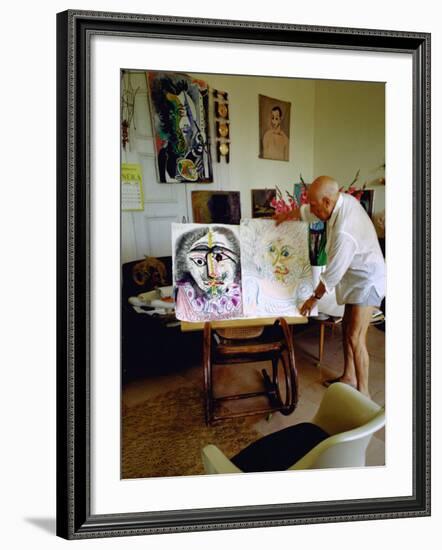 Pablo Picasso Arranging Displays of His Paintings at His Home in Notre-Dame-De-Vie, Mougins-Gjon Mili-Framed Premium Photographic Print