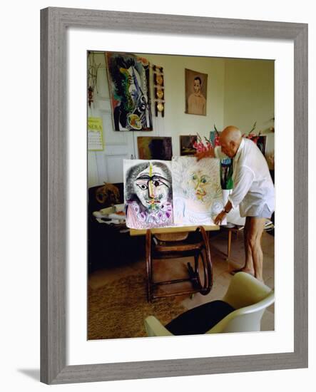 Pablo Picasso Arranging Displays of His Paintings at His Home in Notre-Dame-De-Vie, Mougins-Gjon Mili-Framed Premium Photographic Print