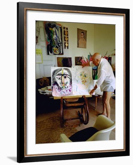 Pablo Picasso Arranging Displays of His Paintings at His Home in Notre-Dame-De-Vie, Mougins-Gjon Mili-Framed Premium Photographic Print