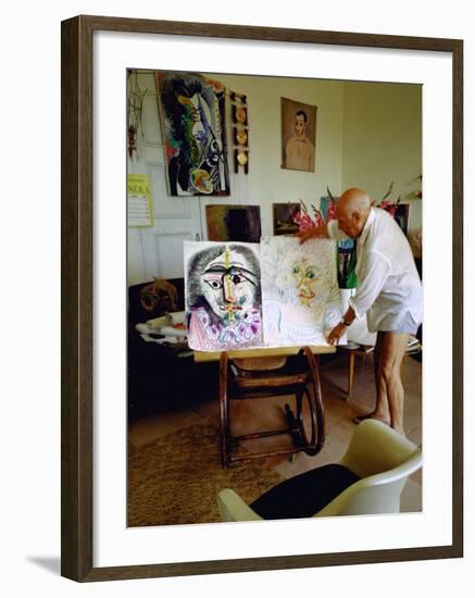 Pablo Picasso Arranging Displays of His Paintings at His Home in Notre-Dame-De-Vie, Mougins-Gjon Mili-Framed Premium Photographic Print