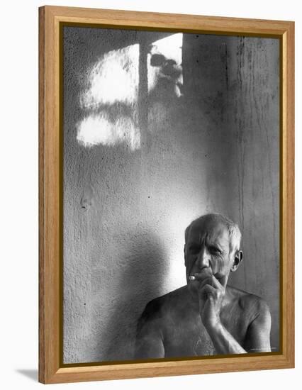 Pablo Picasso, Bare Chested and Smoking Cigarette-Gjon Mili-Framed Premier Image Canvas